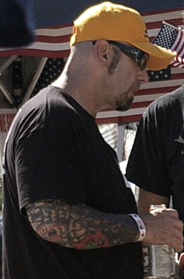 Guy with Yellow Cap Sports Aryan Brotherhood Tattoo on Elbow